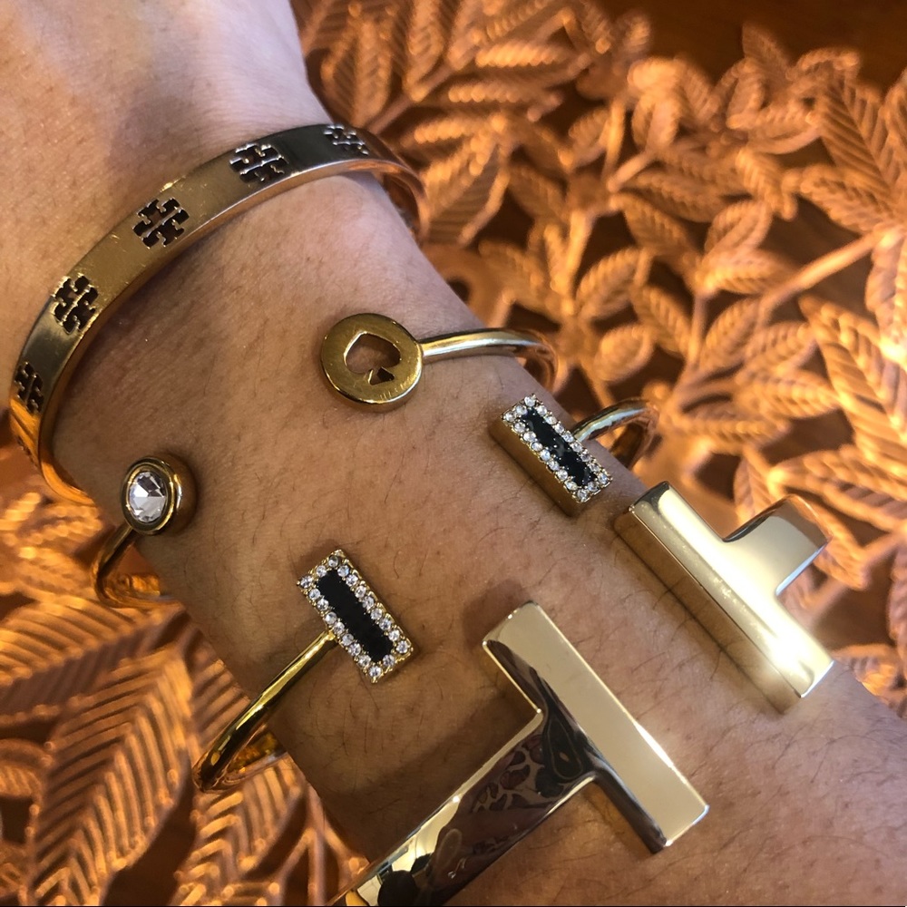 4 bangles Tory Burch, 2 Kate Spade, and a gold bangle